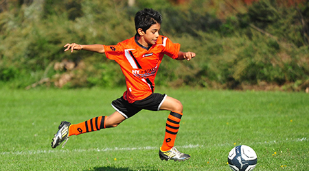 niño jugando al fútbol